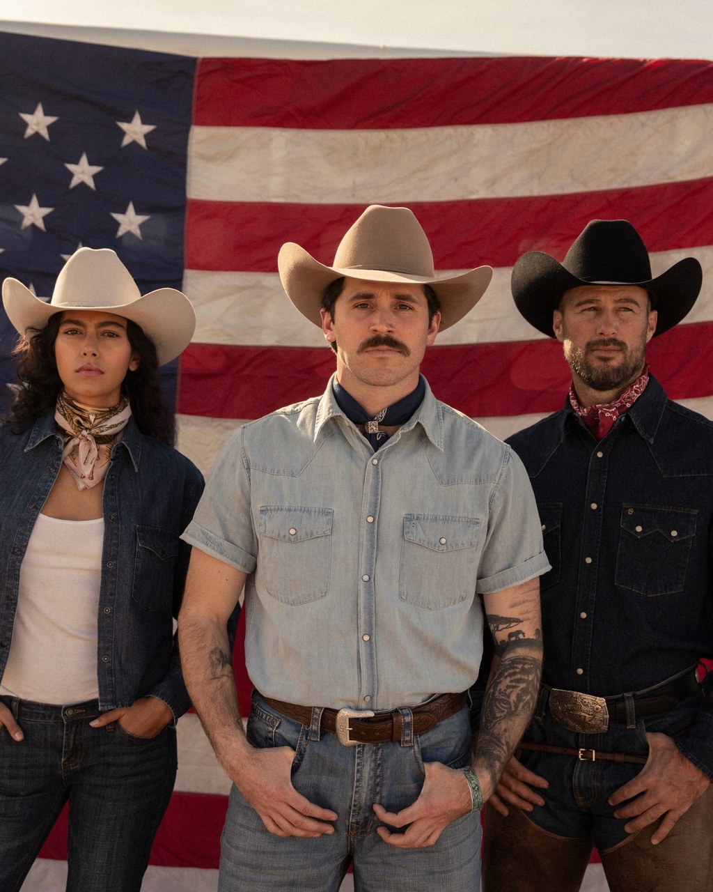 Stetson Western campaign: three talent in cowboy hats before an American flag, consistent grooming across the group