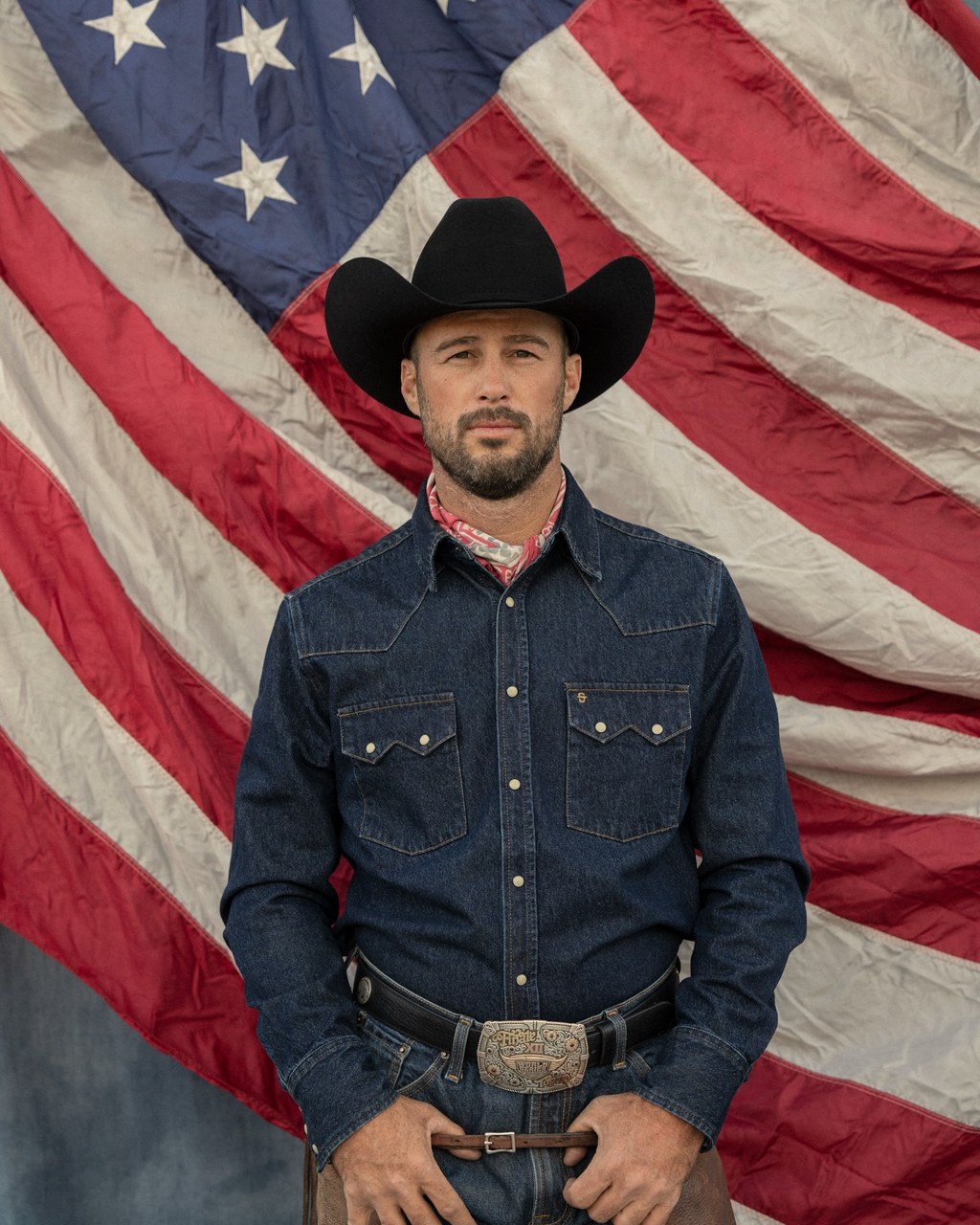 Stetson Western campaign: bearded man in black cowboy hat before an American flag, groomed beard and natural skin